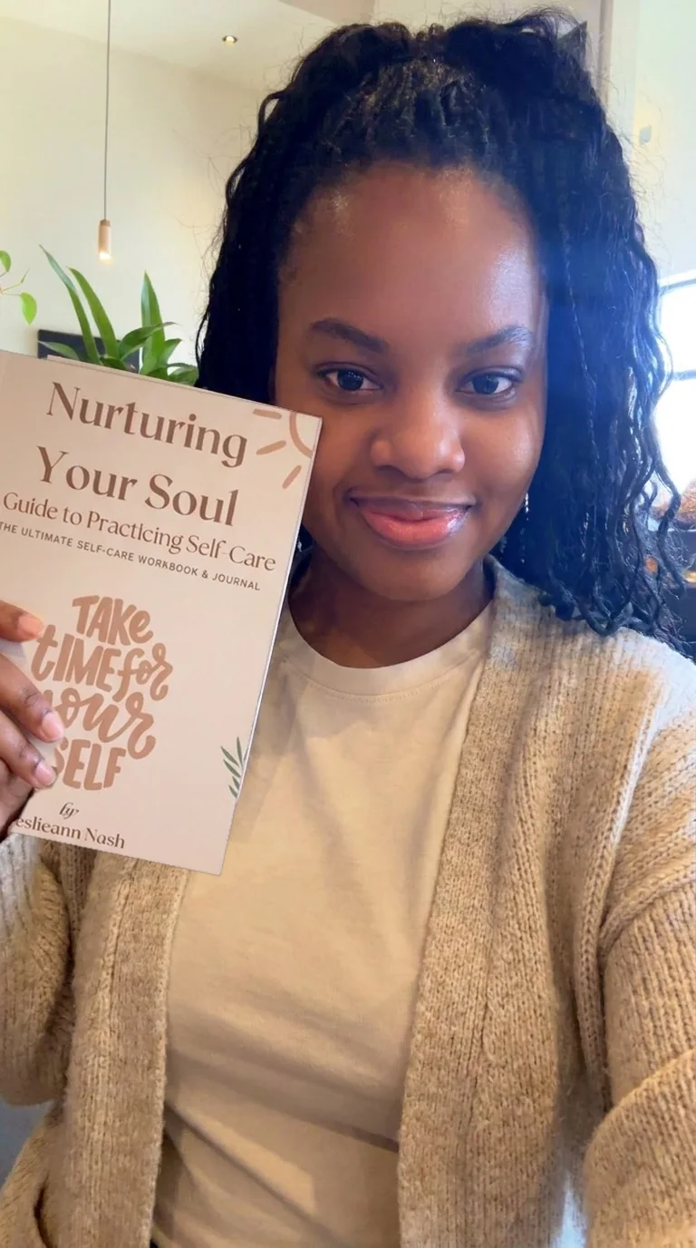 Leslieann smiling and holding the cover of Nurturing Your Soul, which reads Take Time For Yourself